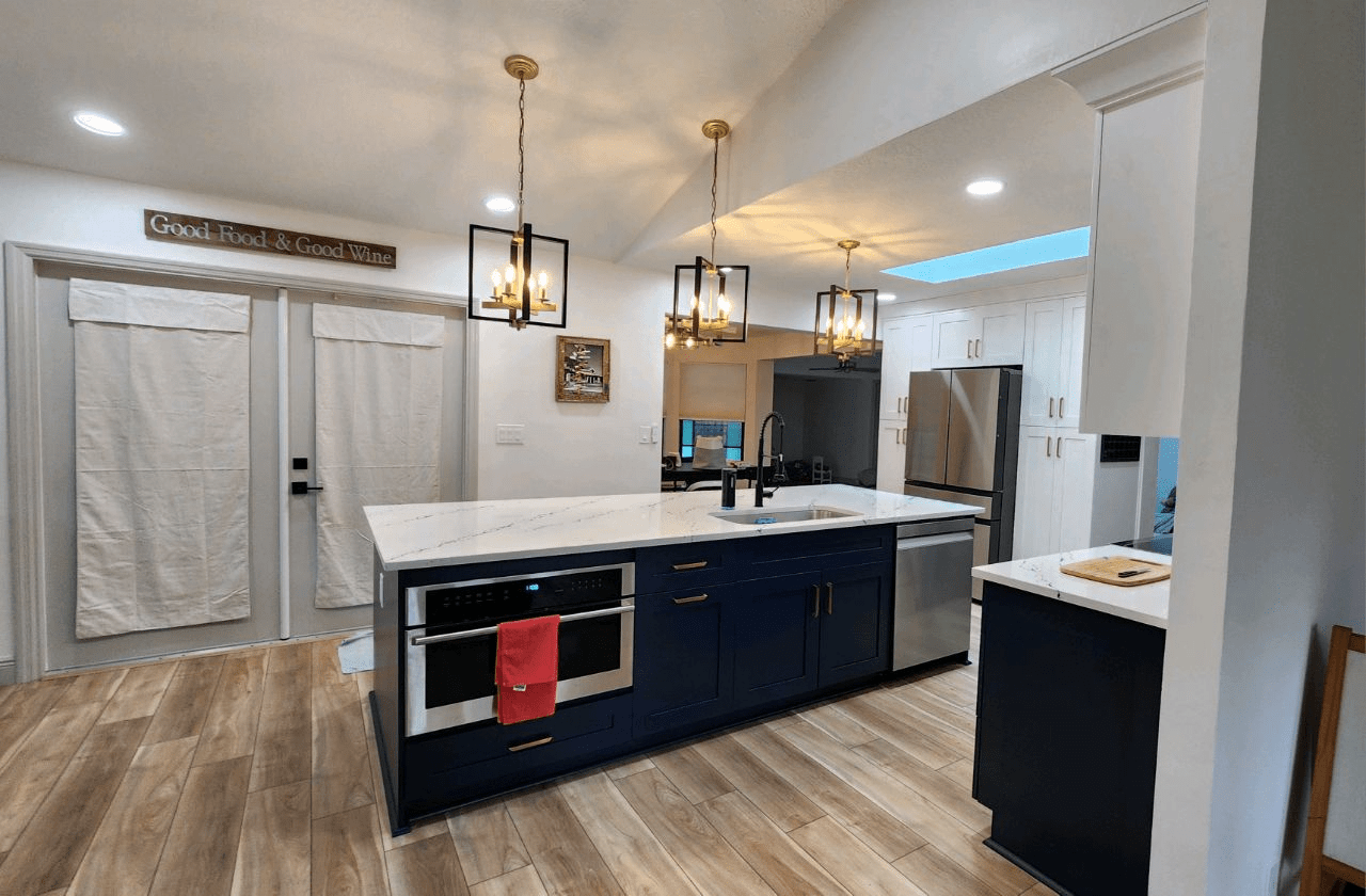 Navy island kitchen with pendant lighting